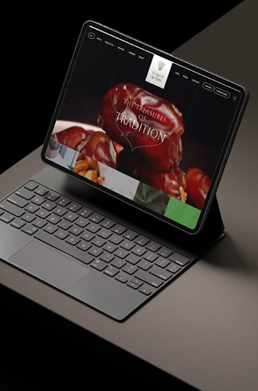  A tablet with a keyboard sits next to a laptop on a wooden table, showcasing a modern workspace setup.